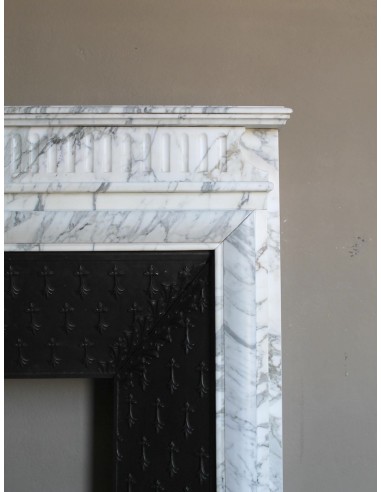 Antique “Boudin” fireplace mantel carved in veined white Calacatta marble. This mantel has its original cast iron insert.