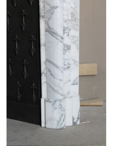 Antique “Boudin” fireplace mantel carved in veined white Calacatta marble. This mantel has its original cast iron insert.