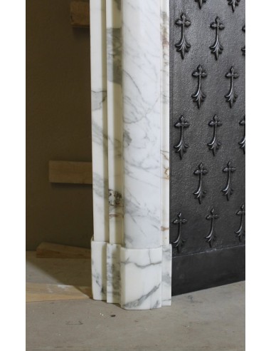 Antique “Boudin” fireplace mantel carved in veined white Calacatta marble. This mantel has its original cast iron insert.