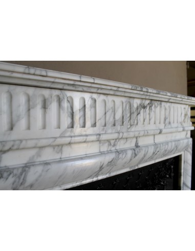 Antique “Boudin” fireplace mantel carved in veined white Calacatta marble. This mantel has its original cast iron insert.