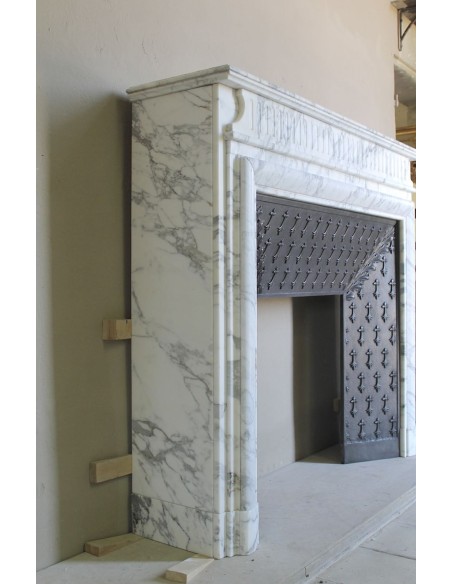 Antique “Boudin” fireplace mantel carved in veined white Calacatta marble. This mantel has its original cast iron insert.