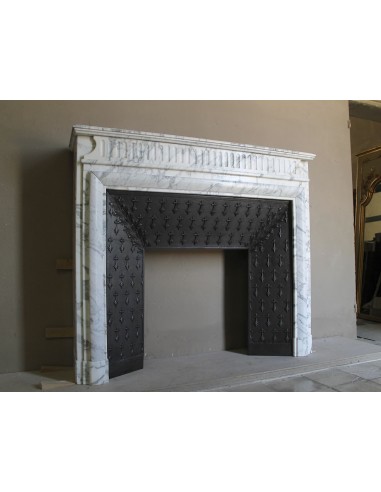 Antique “Boudin” fireplace mantel carved in veined white Calacatta marble. This mantel has its original cast iron insert.
