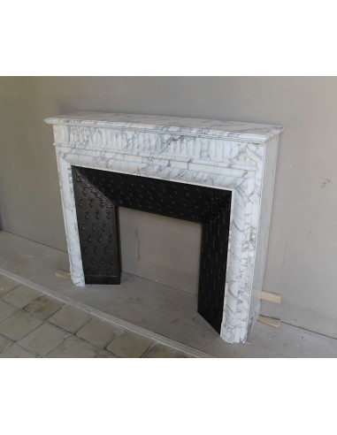 Antique “Boudin” fireplace mantel carved in veined white Calacatta marble. This mantel has its original cast iron insert.