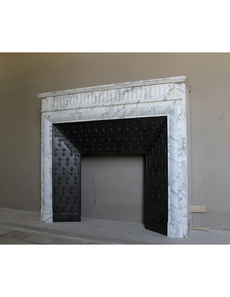 Antique “Boudin” fireplace mantel carved in veined white Calacatta marble. This mantel has its original cast iron insert.