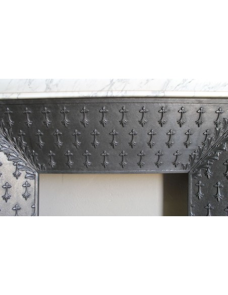 Antique “Boudin” fireplace mantel carved in veined white Calacatta marble. This mantel has its original cast iron insert.