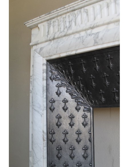 Antique “Boudin” fireplace mantel carved in veined white Calacatta marble. This mantel has its original cast iron insert.