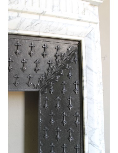 Antique “Boudin” fireplace mantel carved in veined white Calacatta marble. This mantel has its original cast iron insert.