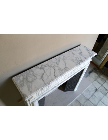 Antique “Boudin” fireplace mantel carved in veined white Calacatta marble. This mantel has its original cast iron insert.