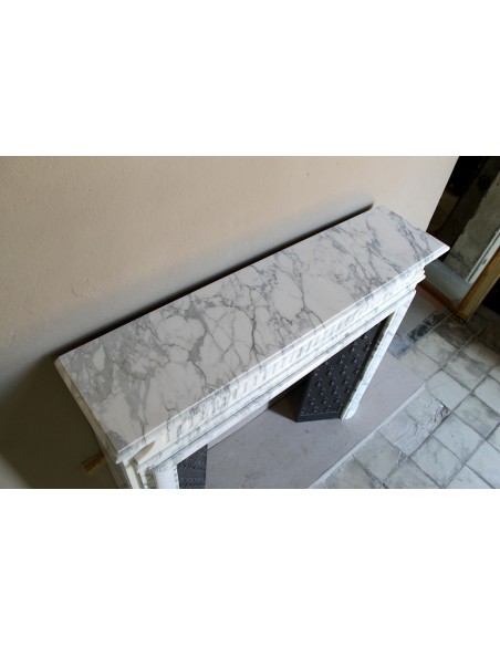 Antique “Boudin” fireplace mantel carved in veined white Calacatta marble. This mantel has its original cast iron insert.