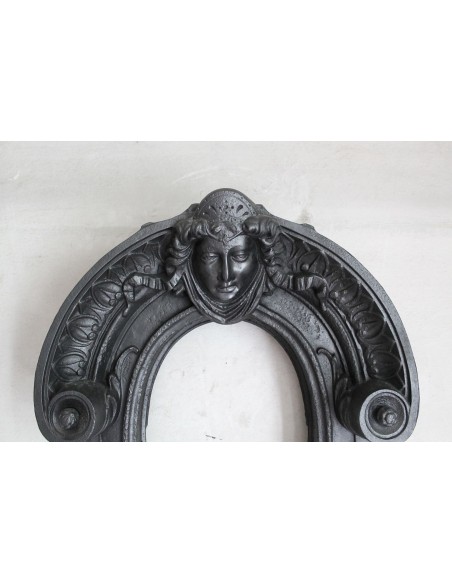 Cast iron Oeil de boeuf “Tête de Femme” mantelpiece. This mantel is genuine, authentic, signed by Majorelle.
