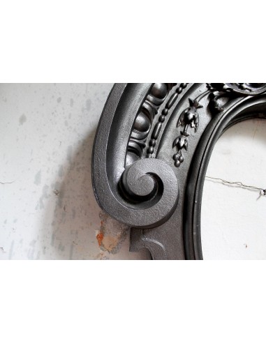 Antique Art Nouveau fireplace mantel in artistic cast iron. This antique mantelpiece is a genuine Parisian “Oeil de boeuf”.