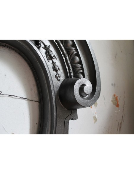 Antique Art Nouveau fireplace mantel in artistic cast iron. This antique mantelpiece is a genuine Parisian “Oeil de boeuf”.