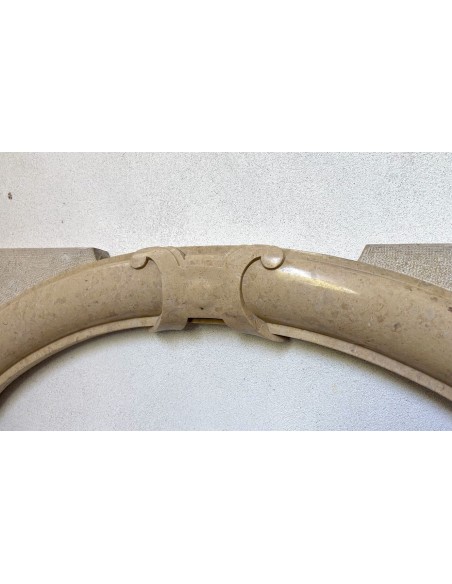 Antique Art Deco style fireplace mantel, carved in taupe marble. This suspended oeil de boeuf mantelpiece is totally original.