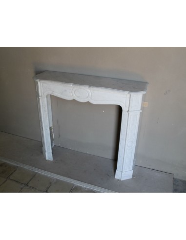 Beautiful mantelpiece carved in white Carrara marble. This fireplace mantel is antique and genuine, Louis XV style.