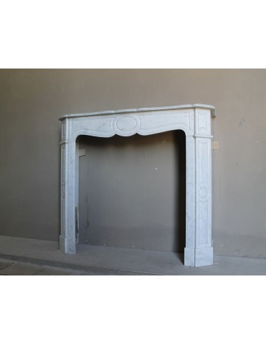 Beautiful mantelpiece carved in white Carrara marble. This fireplace mantel is antique and genuine, Louis XV style.