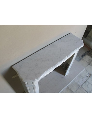 Beautiful mantelpiece carved in white Carrara marble. This fireplace mantel is antique and genuine, Louis XV style.