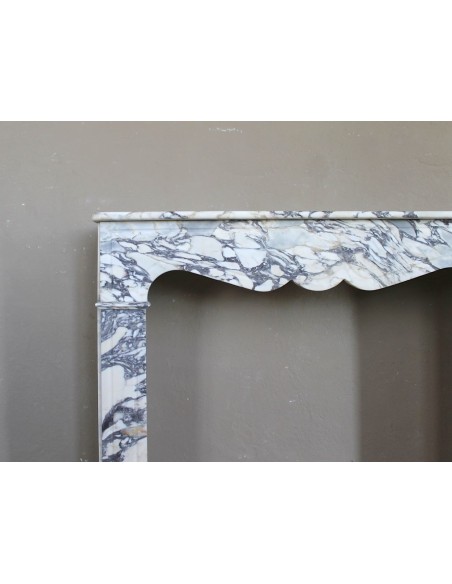 Antique Louis XV “Pompadour Plat” fireplace in Breccia Medicea marble, with veining from white to blue, purple to gold.
