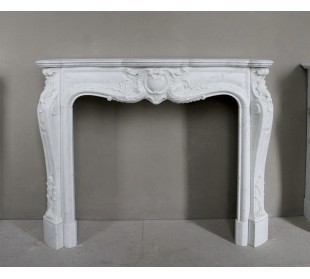 Antique white marble fireplace of Baroque style, 19th-century period, with floral decorations and fine carvings.
