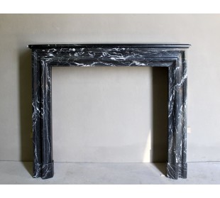Antique “Bolection" mantelpiece in black marble with white veins. This is an elegant, contemporary and minimalist mantel.