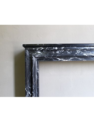 Antique “Bolection" mantelpiece in black marble with white veins. This is an elegant, contemporary and minimalist mantel.