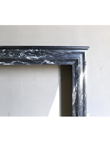 Antique “Bolection" mantelpiece in black marble with white veins. This is an elegant, contemporary and minimalist mantel.