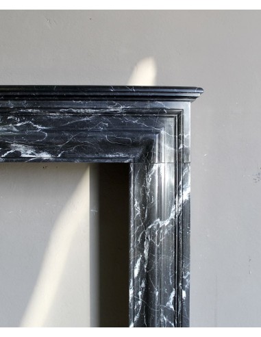 Antique “Bolection" mantelpiece in black marble with white veins. This is an elegant, contemporary and minimalist mantel.