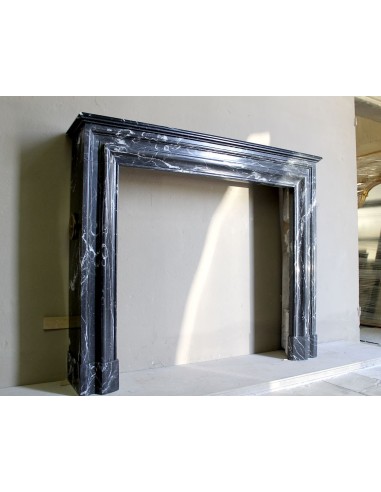 Antique “Bolection" mantelpiece in black marble with white veins. This is an elegant, contemporary and minimalist mantel.