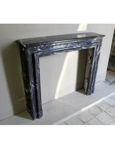 Antique “Bolection" mantelpiece in black marble with white veins. This is an elegant, contemporary and minimalist mantel.