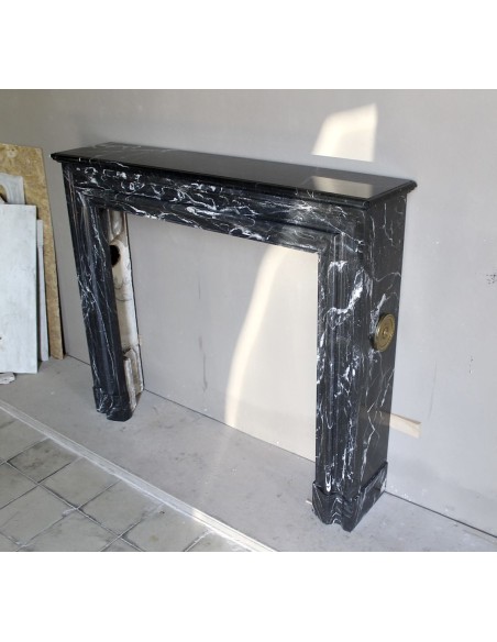 Antique “Bolection" mantelpiece in black marble with white veins. This is an elegant, contemporary and minimalist mantel.