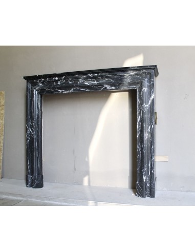 Antique “Bolection" mantelpiece in black marble with white veins. This is an elegant, contemporary and minimalist mantel.