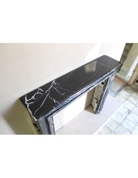 Antique “Bolection" mantelpiece in black marble with white veins. This is an elegant, contemporary and minimalist mantel.