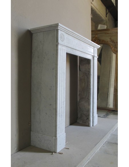 Neoclassical-style fireplace mantel carved in white Carrara marble. This mantelpiece is outstanding for its small and nice size.