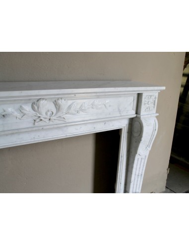Louis XVI “Olive Branch” fireplace mantel with floral carvings in white marble, mid 20th century, offered at a discounted price.