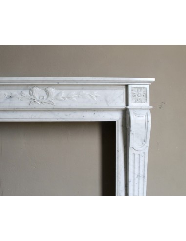 Louis XVI “Olive Branch” fireplace mantel with floral carvings in white marble, mid 20th century, offered at a discounted price.