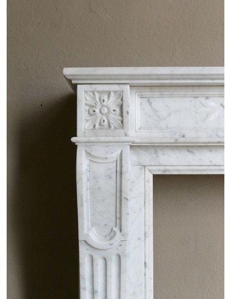 Louis XVI “Olive Branch” fireplace mantel with floral carvings in white marble, mid 20th century, offered at a discounted price.