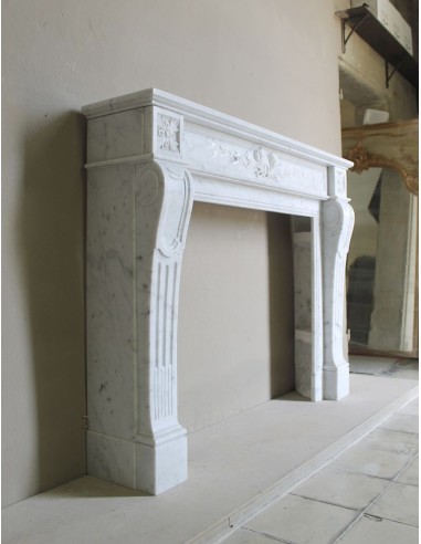 Louis XVI “Olive Branch” fireplace mantel with floral carvings in white marble, mid 20th century, offered at a discounted price.