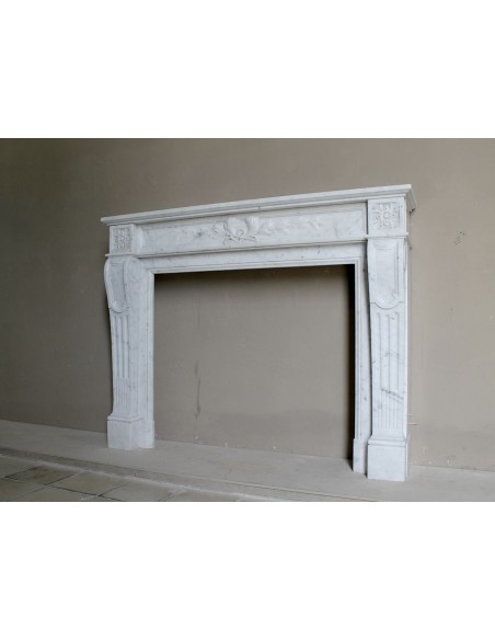 Louis XVI “Olive Branch” fireplace mantel with floral carvings in white marble, mid 20th century, offered at a discounted price.