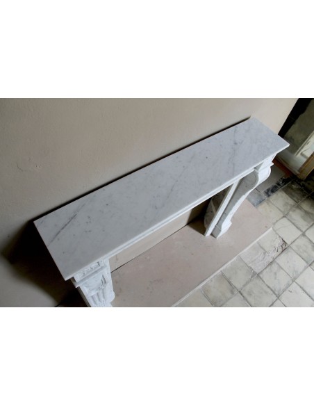 Louis XVI “Olive Branch” fireplace mantel with floral carvings in white marble, mid 20th century, offered at a discounted price.