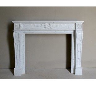 Louis XVI “Olive Branch” fireplace mantel with floral carvings in white marble, mid 20th century, offered at a discounted price.