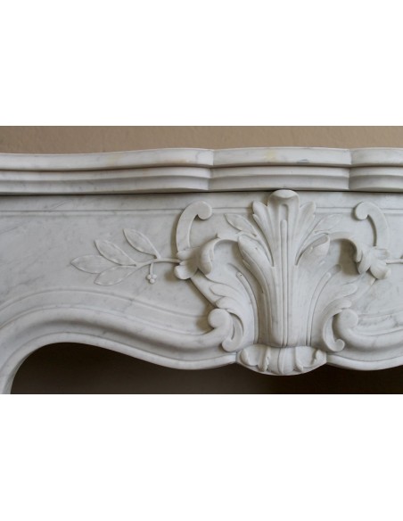 Extremely rare baroque fireplace of very small dimensions and significant decorative carvings in white Carrara marble.