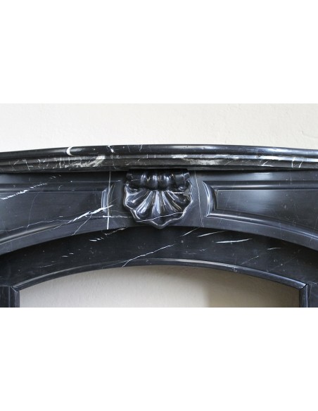 Large antique Louis XIV "Arquée" fireplace mantel in Black Marquinia marble with contrasting white veins and shell decoration.