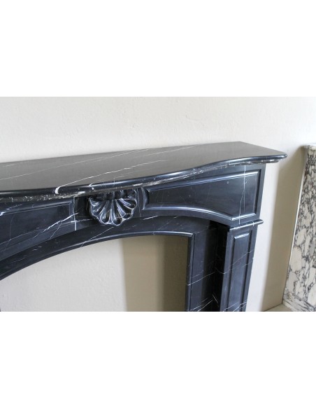 Large antique Louis XIV "Arquée" fireplace mantel in Black Marquinia marble with contrasting white veins and shell decoration.