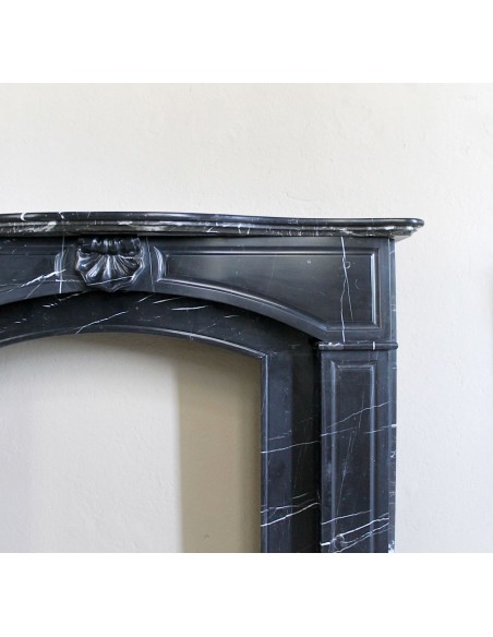 Large antique Louis XIV "Arquée" fireplace mantel in Black Marquinia marble with contrasting white veins and shell decoration.