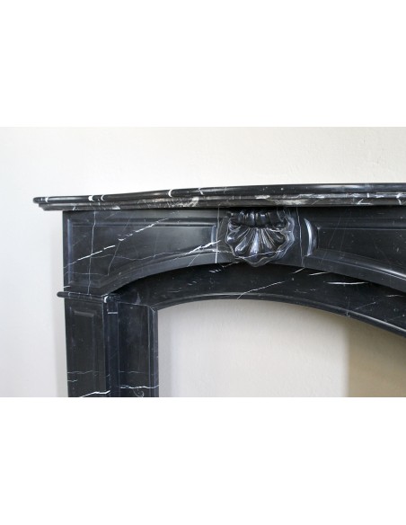Large antique Louis XIV "Arquée" fireplace mantel in Black Marquinia marble with contrasting white veins and shell decoration.