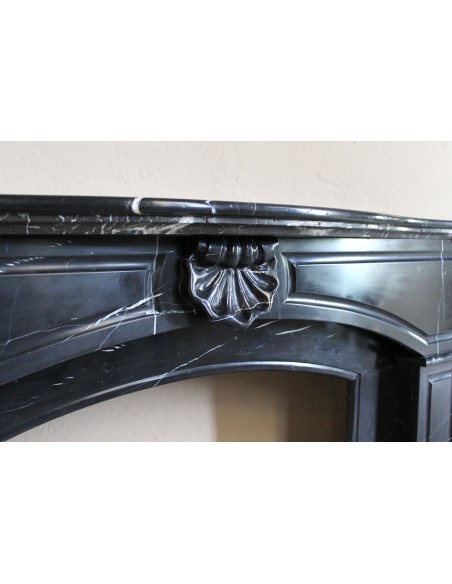 Large antique Louis XIV "Arquée" fireplace mantel in Black Marquinia marble with contrasting white veins and shell decoration.