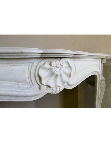 Antique Louis XV “Coquille” fireplace mantel of great stylistic refinement carved in white Carrara marble.