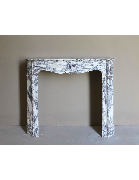 Small antique Baroque fireplace carved in very rare and famous Breccia Violetta marble, an elegant and colorful marble.