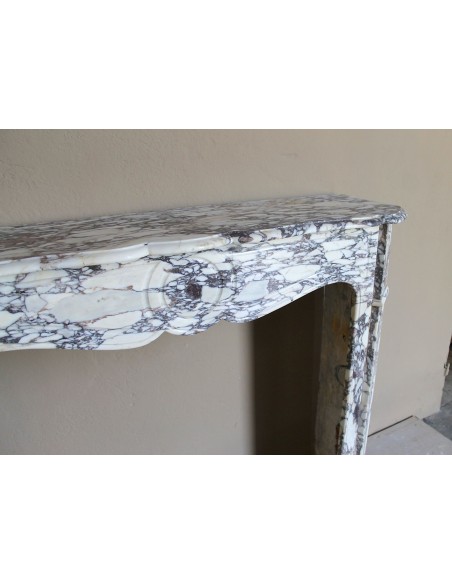 Small antique Baroque fireplace carved in very rare and famous Breccia Violetta marble, an elegant and colorful marble.