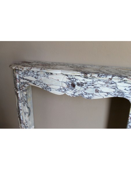 Small antique Baroque fireplace carved in very rare and famous Breccia Violetta marble, an elegant and colorful marble.