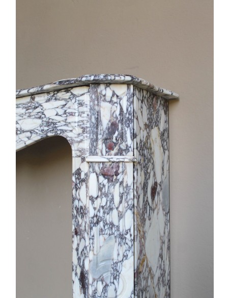 Small antique Baroque fireplace carved in very rare and famous Breccia Violetta marble, an elegant and colorful marble.